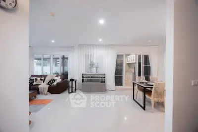 Spacious open-plan living and dining area with modern decor and natural light