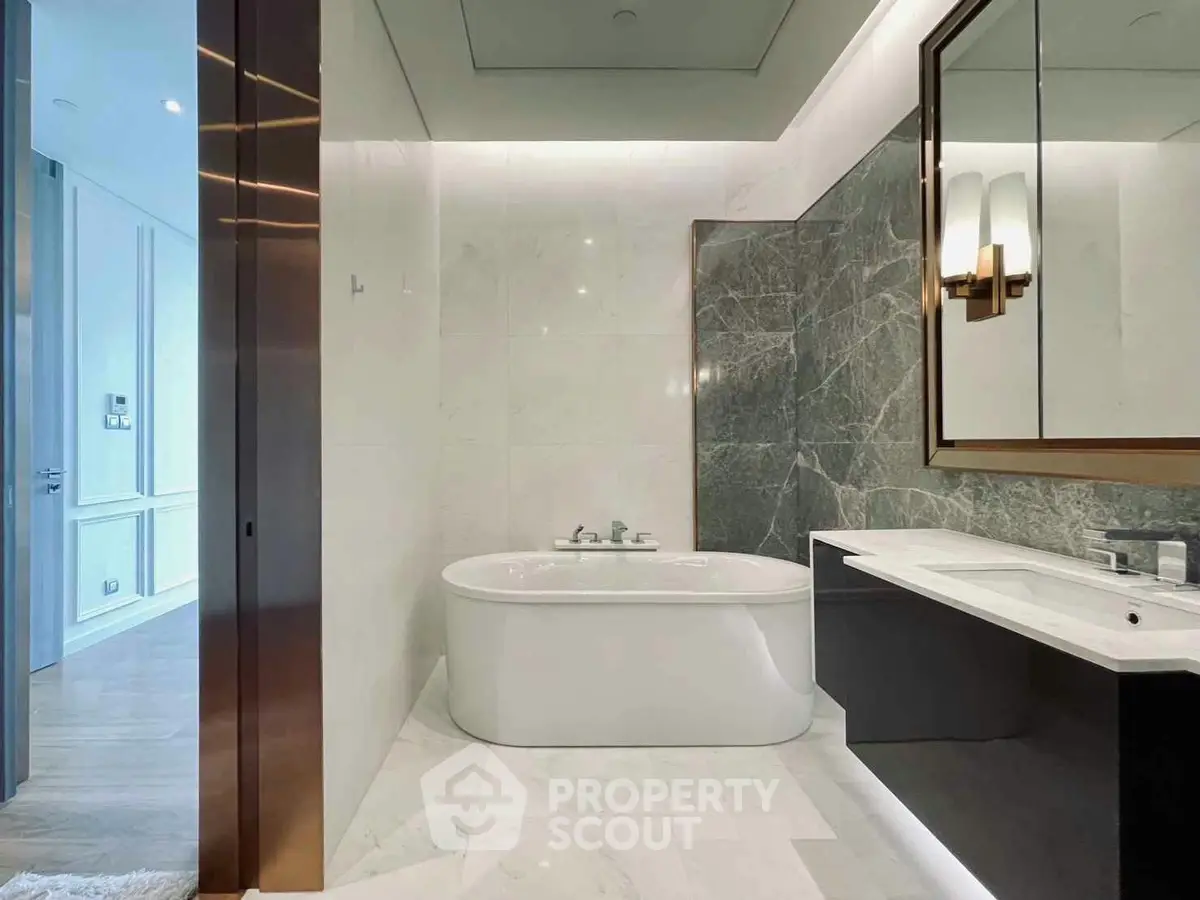 Luxurious modern bathroom with elegant marble finishes and stylish fixtures.