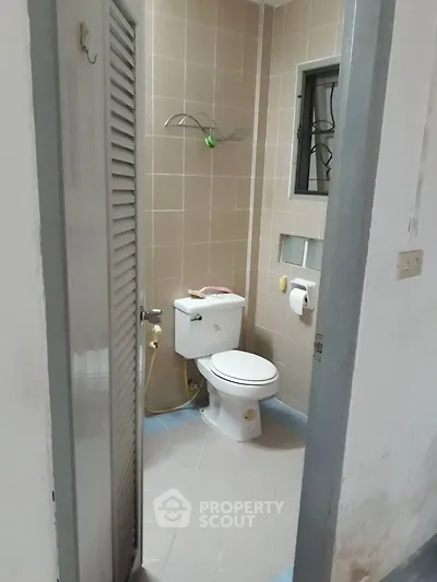 Compact bathroom with tiled walls and standard fixtures