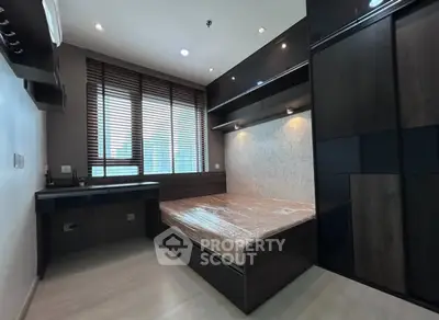 Modern bedroom with sleek dark wood furniture and large window blinds