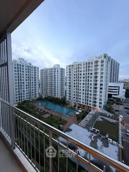 Stunning view of modern apartment complex with pool and garden from balcony