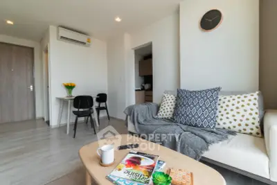 Modern living room with cozy sofa, stylish decor, and open layout in a contemporary apartment.