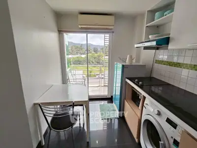 Modern kitchen with washing machine and scenic balcony view