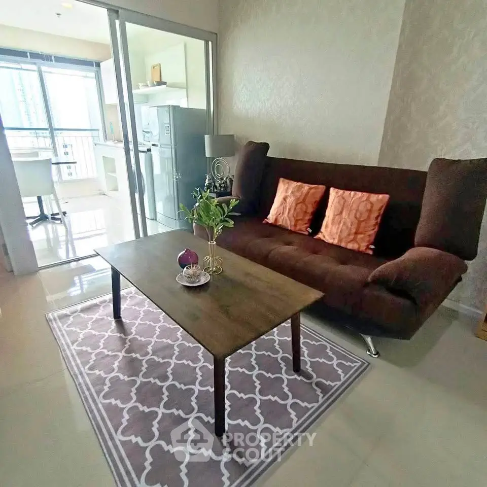 Modern living room with stylish sofa and open kitchen view