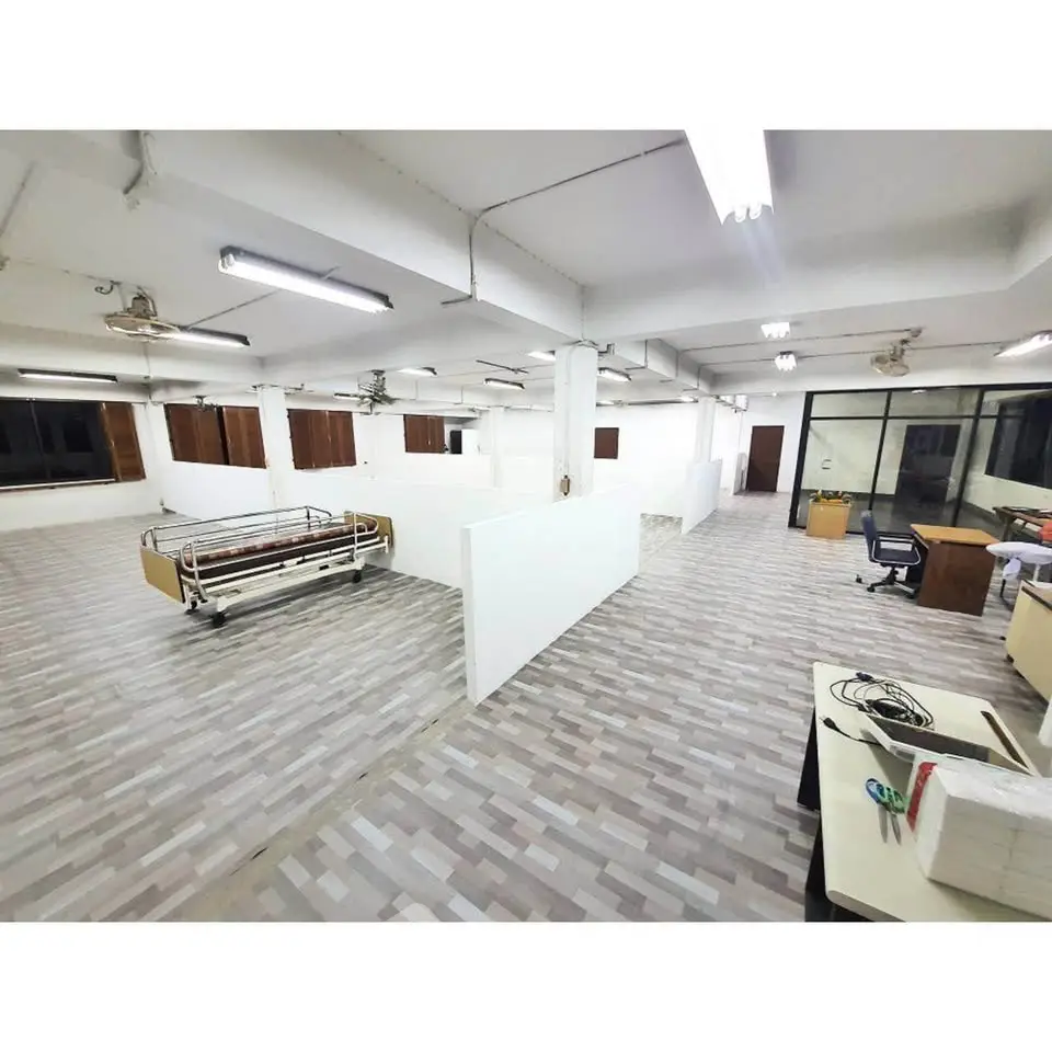 Spacious open-plan office space with modern flooring and ample natural light.