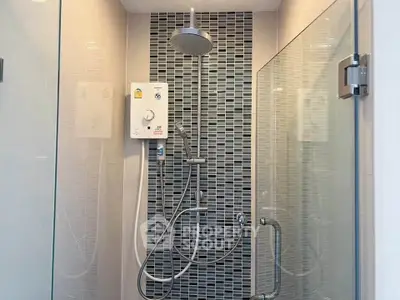 Modern bathroom shower with glass doors and sleek tile design.