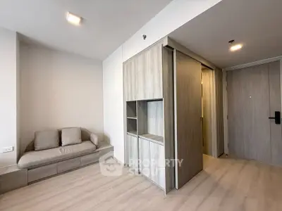 Modern minimalist living room with light wood flooring and built-in storage