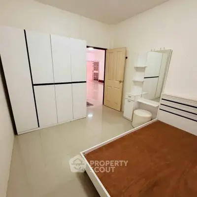 Spacious bedroom with modern furniture and ample storage space