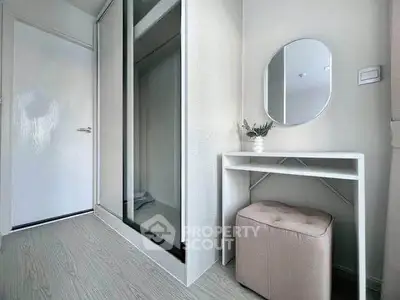 Modern minimalist bedroom corner with sleek wardrobe and stylish vanity setup.