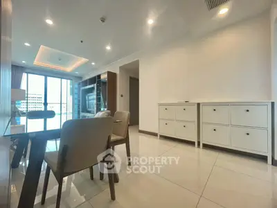 Spacious modern living room with elegant dining area and large windows for natural light.