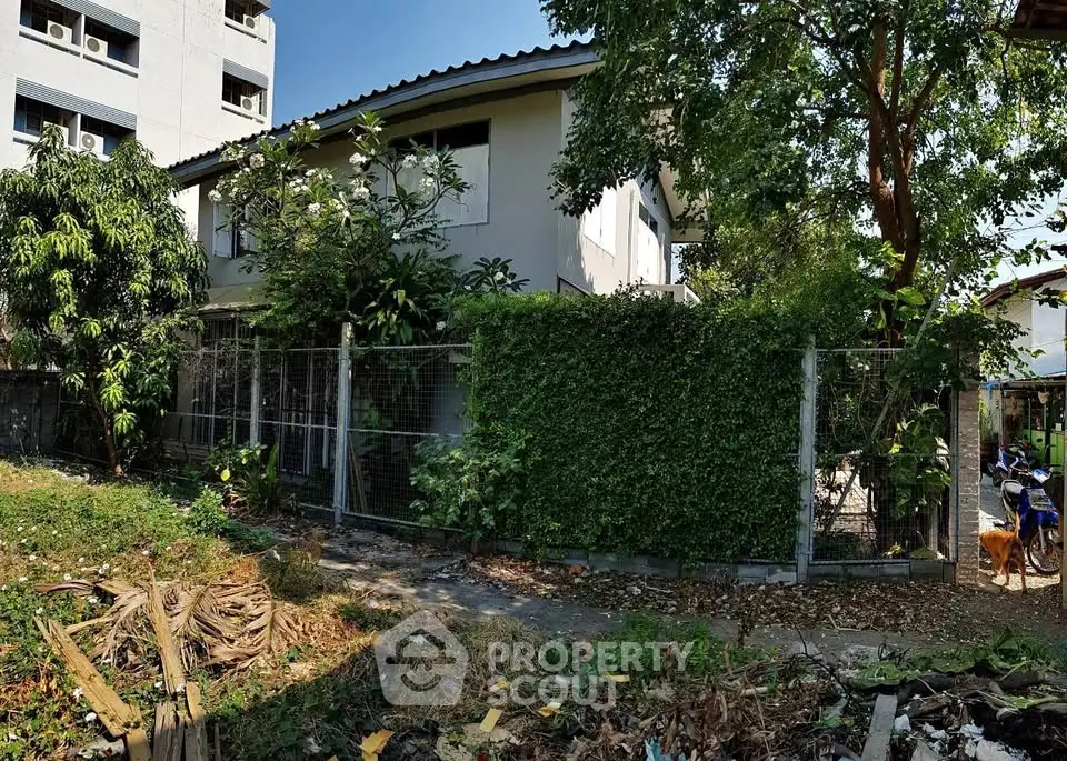 Charming suburban house with lush greenery and spacious yard, perfect for family living.