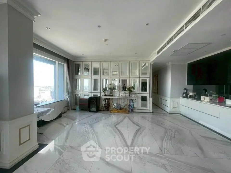 Luxurious open living space with marble flooring and panoramic window view