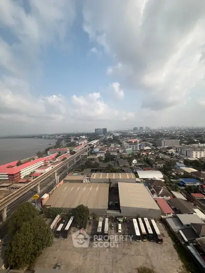 Stunning aerial view of urban landscape with river and city skyline, perfect for real estate investment.