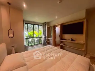 Luxurious bedroom with large window and modern decor, offering a serene garden view.