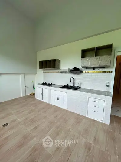 Spacious kitchen with modern open layout and gas stove, perfect for culinary enthusiasts.
