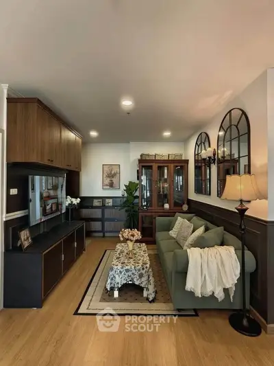 Elegant living room with stylish decor, cozy sofa, and modern entertainment center in a well-lit space.