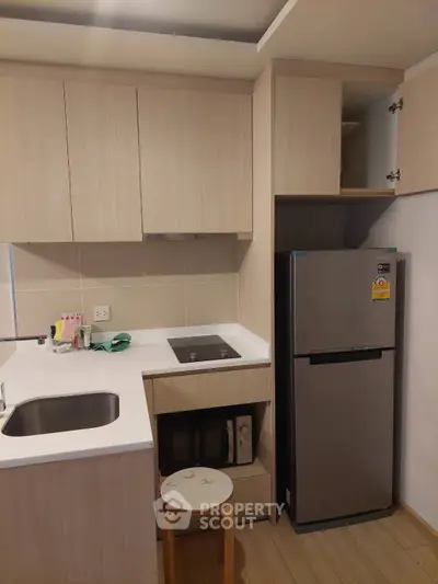 Modern compact kitchen with sleek cabinetry and stainless steel appliances