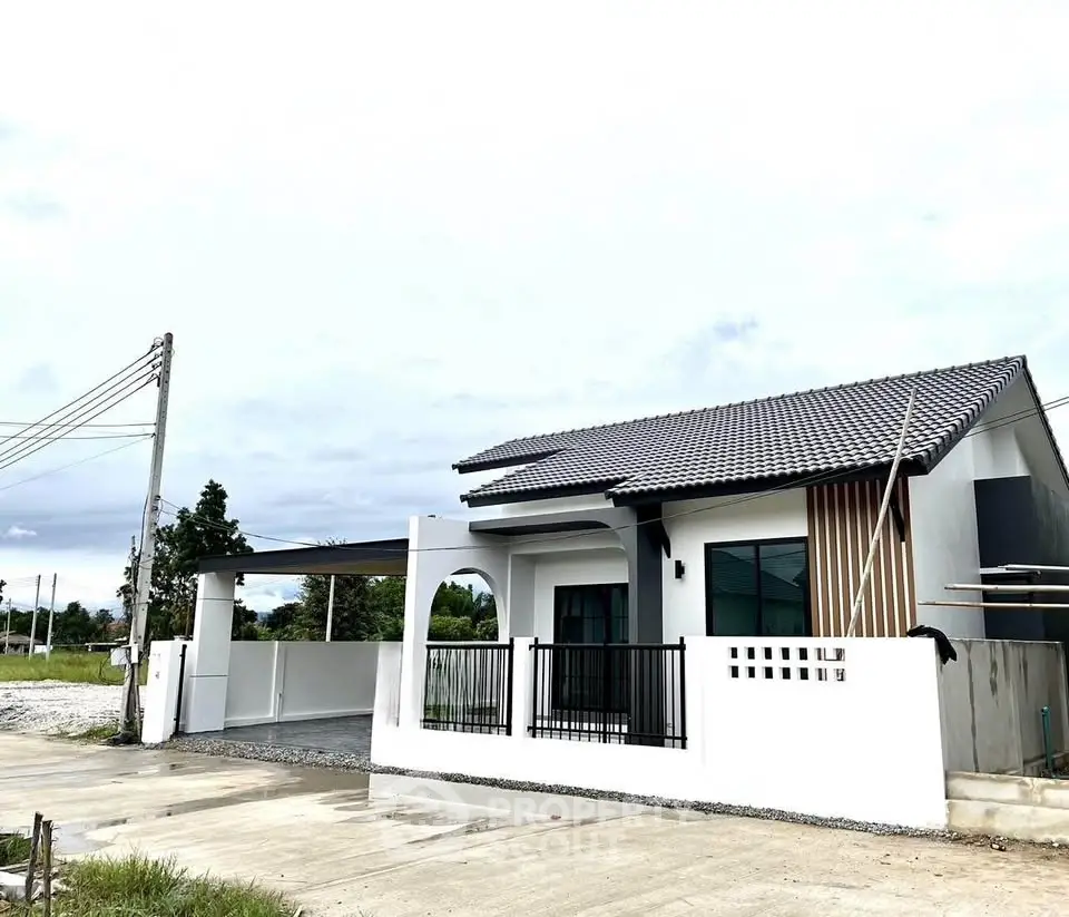 Modern single-story house with stylish facade and spacious driveway.