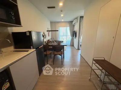 Modern open-layout kitchen and dining area with sleek appliances and stylish decor.