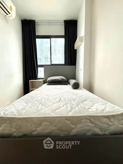 Cozy bedroom with modern design and large window in urban apartment