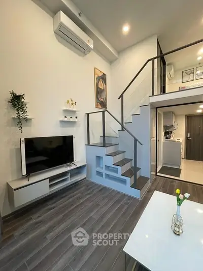 Modern duplex living room with stylish staircase and open kitchen layout