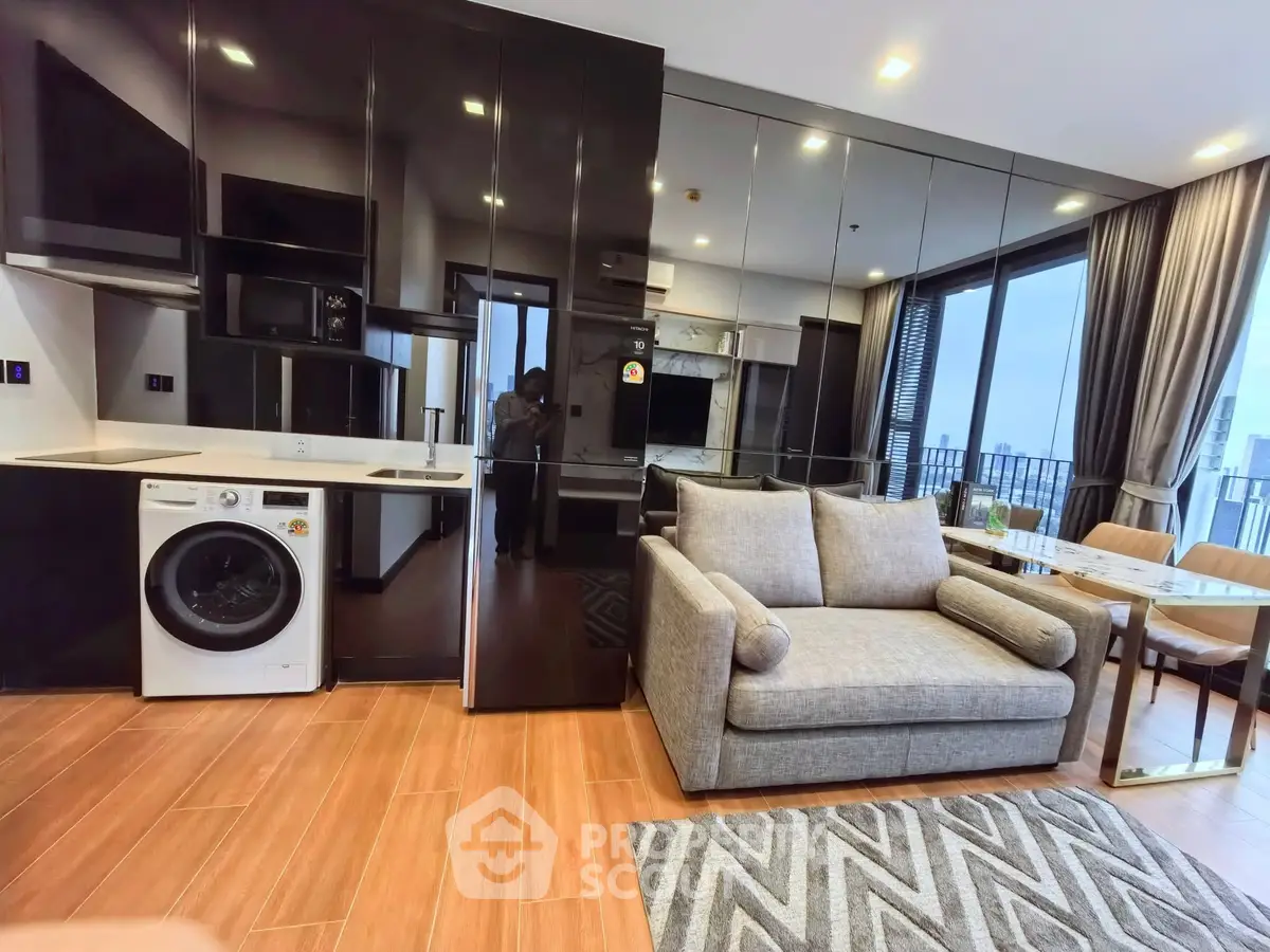Modern open-plan living room with sleek kitchen and large windows offering city views.