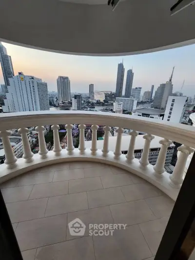 Stunning cityscape view from a curved balcony in a high-rise building.