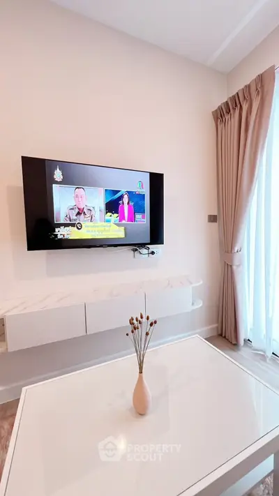 Modern living room with wall-mounted TV and elegant decor