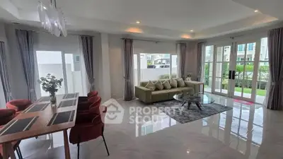 Spacious modern living room with elegant dining area and large windows for natural light.