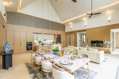 Luxurious open-plan living and dining area with high ceilings and elegant decor