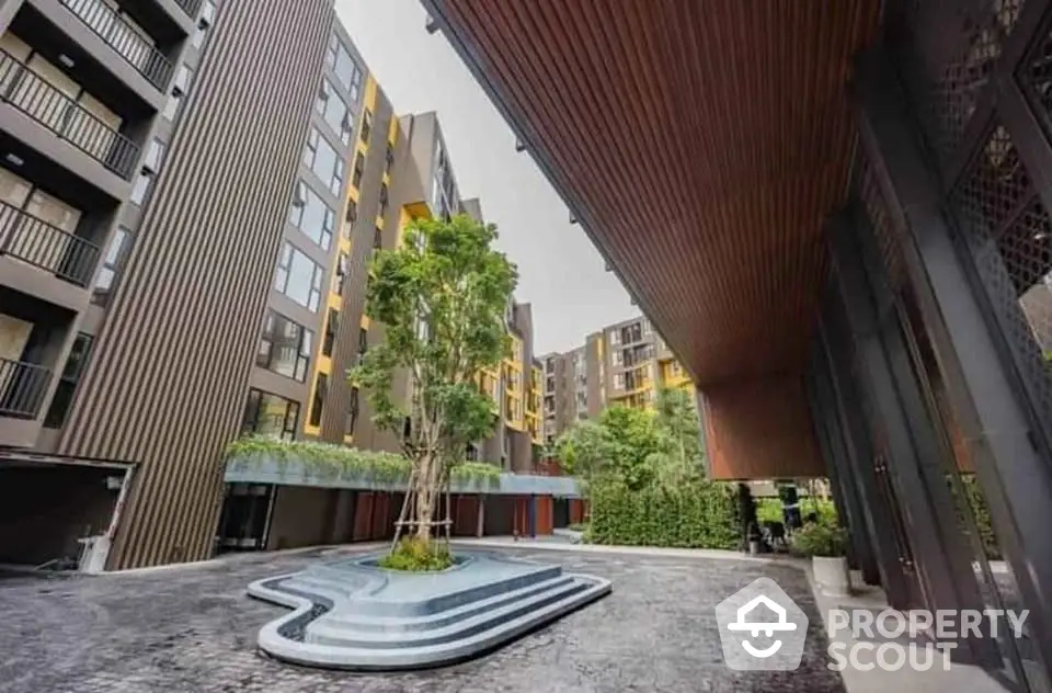 Modern apartment building with unique architectural design and lush greenery