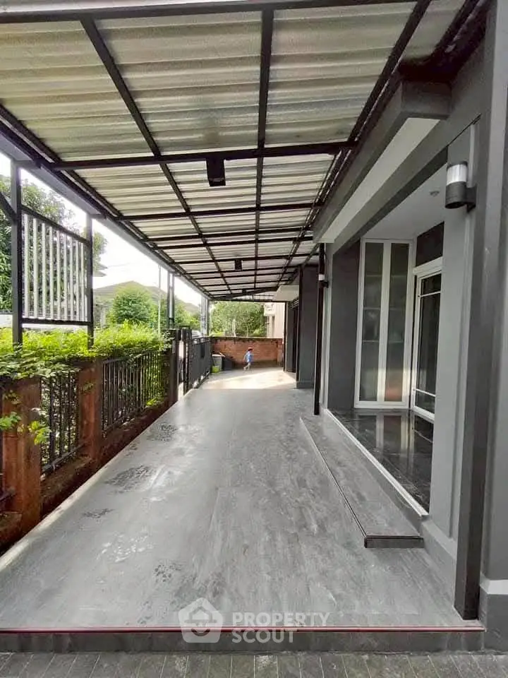 Spacious covered driveway with modern design and lush greenery