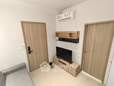 Modern living room with sleek furniture and air conditioning unit, perfect for cozy urban living.