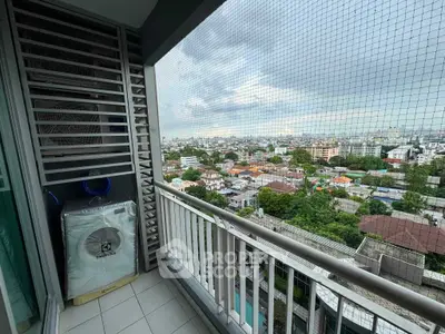 Stunning high-rise balcony with panoramic city views and secure netting, perfect for urban living.