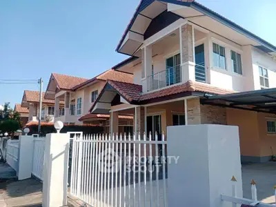 Charming suburban house with red-tiled roof and spacious front yard, perfect for family living.