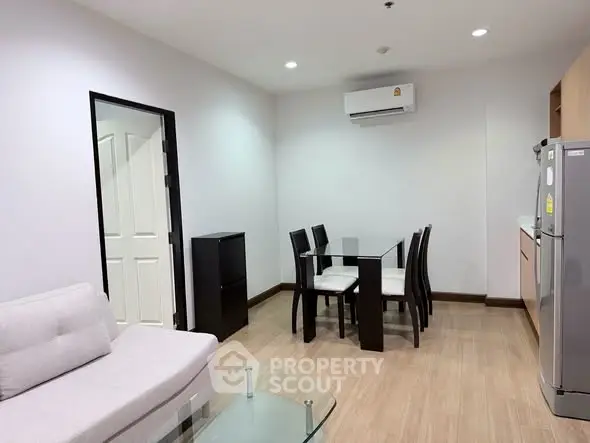Modern living room with dining area and air conditioning in a stylish apartment.