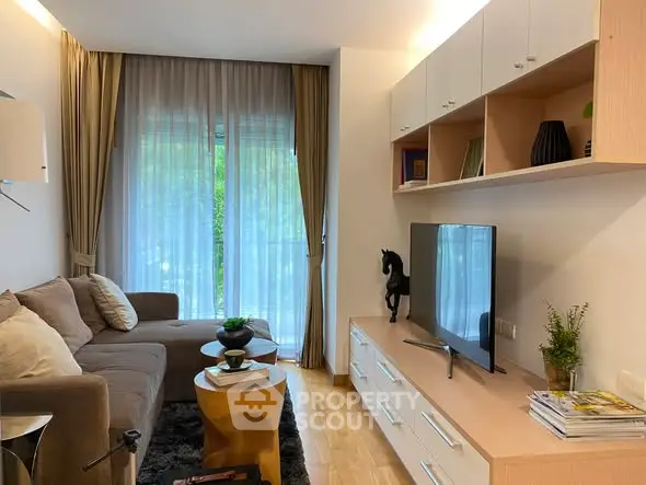 Modern living room with cozy sofa, stylish decor, and large window with curtains.