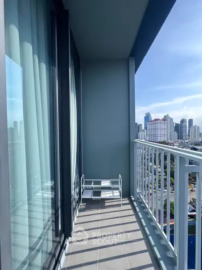 Spacious balcony with stunning city skyline view, perfect for relaxation and enjoying urban living.