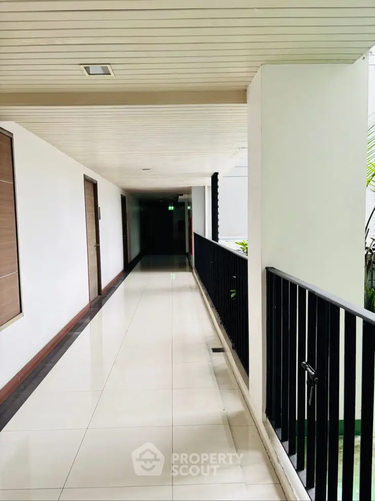 Modern apartment corridor with sleek design and bright lighting