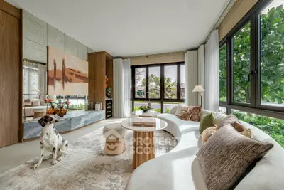 Luxurious living room with modern decor and large windows offering lush garden views.