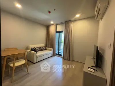 Modern living room with cozy sofa, TV, and dining area in a stylish apartment.