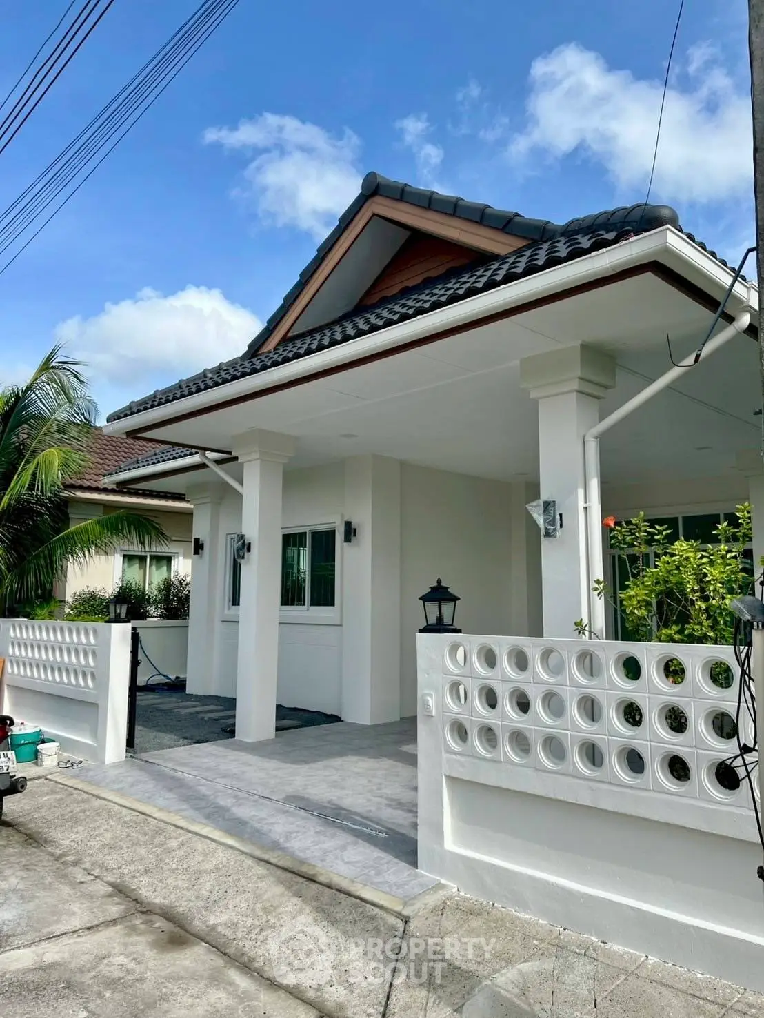 Charming single-story house with modern design and lush garden in a serene neighborhood.
