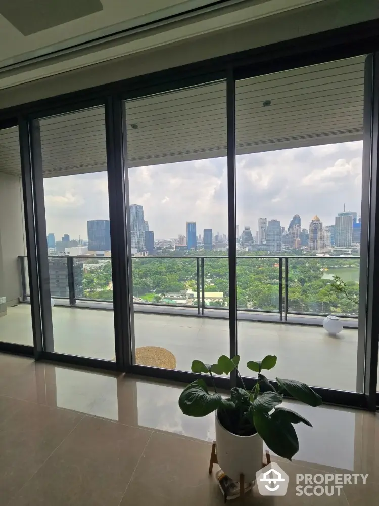 Stunning cityscape view from modern apartment balcony with lush greenery