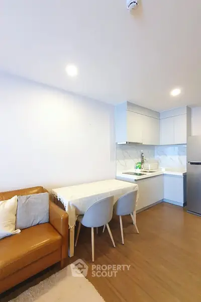 Modern open-layout kitchen with cozy living area and stylish furniture