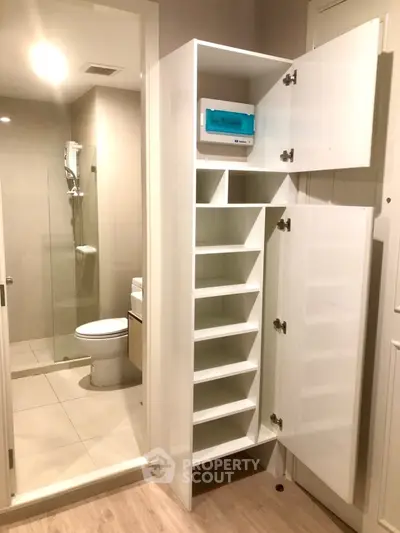Modern bathroom with sleek storage and shower area
