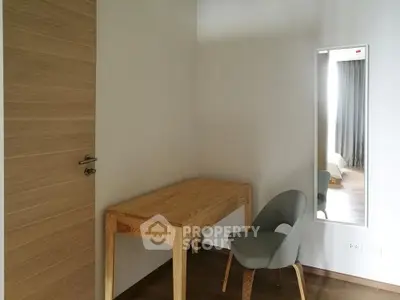 Minimalist study room with wooden desk and modern chair, perfect for focused work.