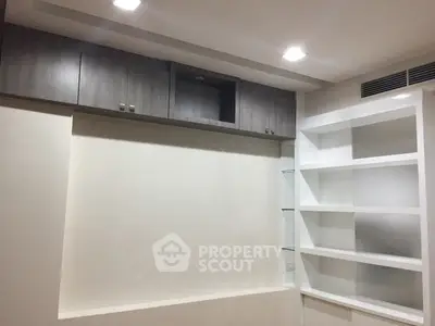 Modern storage space with sleek cabinets and open shelving in a minimalist design.