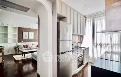 Elegant open-layout kitchen and living room with modern appliances and natural light.