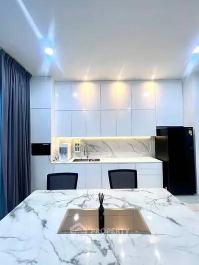Modern kitchen with marble countertops and sleek cabinetry