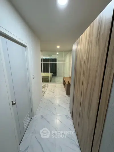 Modern hallway with marble flooring leading to a stylish bedroom